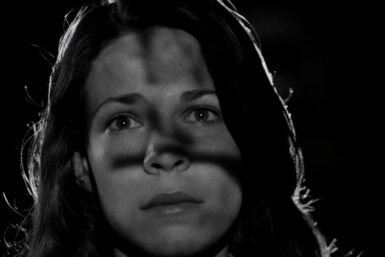 Woman with the shadow of a Cross on her face